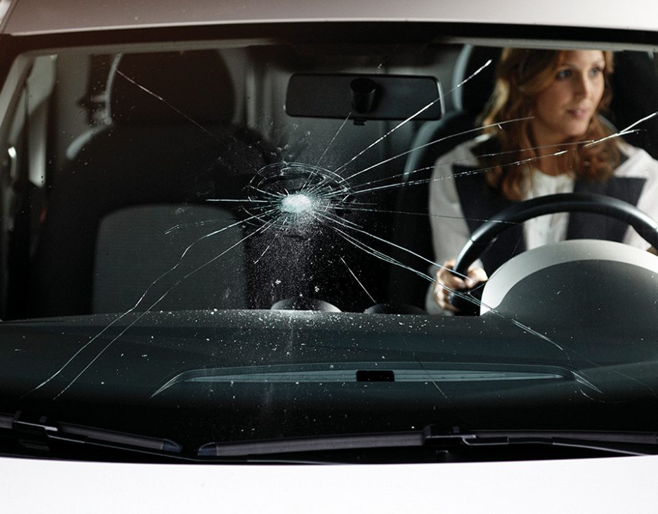 What causes cracks in the windshield of cars
